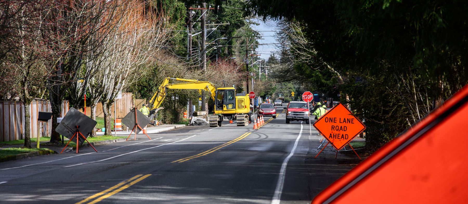 Flagger managing one-lane traffic at a road works project